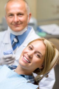 A woman smiling with her dentist